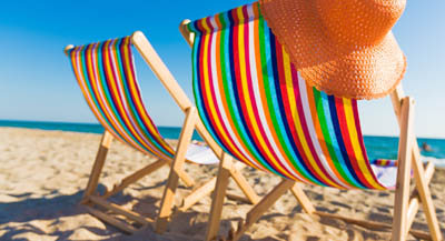 Colourful deck chairs on the beach.