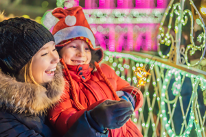 Mother and child enjoying nighttime illuminations.