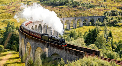 A steam train crossing the Glenfinnan Viaduct in Scotland.