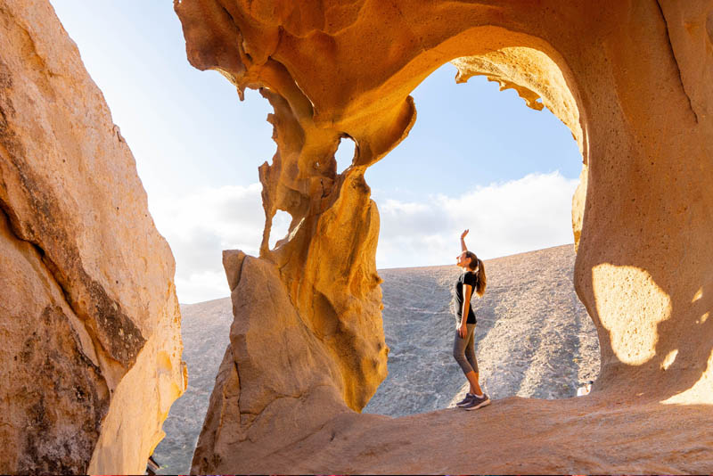 An adventurer exploring exotic natural rock formations