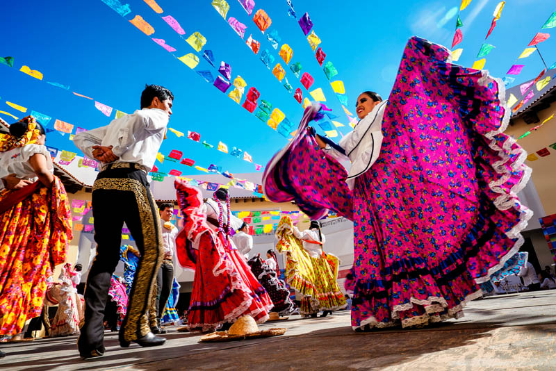 Dancers at a Mexican festival in colourful dress.