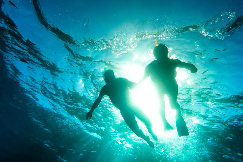 A senior couple snorkelling in a tropical sea.